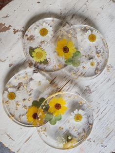 three glass plates with yellow and white flowers on them