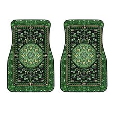 two green and black carpeted floor mats with an intricate design on the front, one in