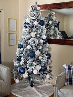 a silver and blue christmas tree in a living room