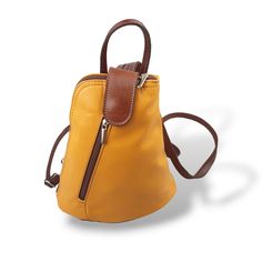 This SMALL Mustard and Brown soft Italian leather backpack is ideal for when you need a bag that is both practical but also very stylish. This SMALL backpack has been handmade by artisans in Italy from the finest Italian Leather and has a certificate of authenticity label inside the bag confirming that it is genuine Italian leather. A perfect bag to for all those essentials such as smartphone, cards, keys and make-up. It is fully lined with an internal zipped pocket for the things you like to ke Small Rucksack, Artisan Bag, Brown Leather Backpack, Small Backpack, Backpack Straps, Perfect Bag, Stylish Bag, Italian Leather, Mustard