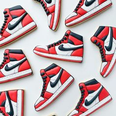 decorated cookies in the shape of air jordans are arranged next to each other on a white surface