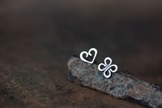 This is a mismatched pair of tiny stud earrings - you are getting one tiny heart and one four leaf clover (Celtic knot) shape. Studs are hand fabricated by me from solid sterling silver. I believe these popular symbols in a pair will make a great gift for someone special :) ● Earrings will be shipped with sterling silver backs ● Heart shape measures approx 6 x 7.5 mm ● Clover (Celtic knot) measures approx 7 x 7 mm If you prefer *matched* earrings: ► Pair of heart studs: http://www.etsy.com/listi Personalized Sterling Silver Heart Earrings As Gift, Delicate Sterling Silver Heart Earrings Gift, Dainty Sterling Silver Heart Earrings As Gift, Handmade Dainty Sterling Silver Heart Earrings, Clover Symbol, Mens Diamond Stud Earrings, Blue Diamond Wedding Ring, One Four, Small Silver Earrings