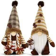 two knitted gnomes are holding hands and wearing hats with buttons on their ears