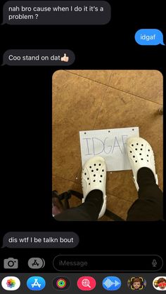 two people standing next to each other with their feet on the ground and one person holding a sign