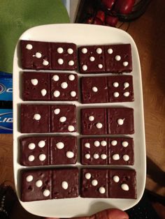 a white plate topped with chocolate dices on top of a table