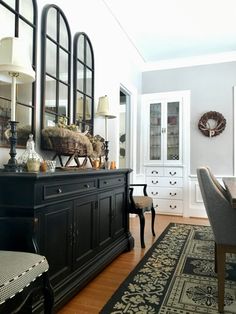 a dining room table with chairs and a china cabinet