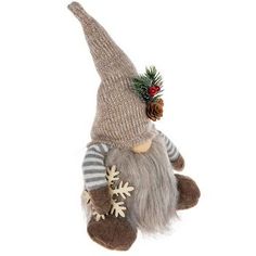 a stuffed animal wearing a knitted hat and striped sweater with snowflakes on it