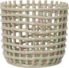 a white basket that is sitting on the ground