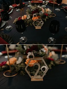 the table is set with black and gold plates, silver candlesticks, and flowers