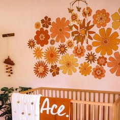 a baby crib in front of a wall with flowers on it