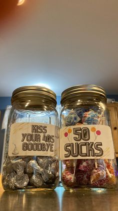 two jars filled with candy sitting on top of a counter