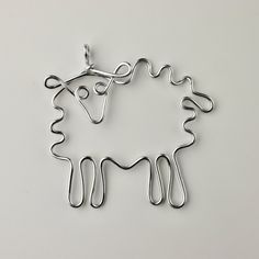 a sheep is shown in the shape of a wire with scissors hanging from it's back end