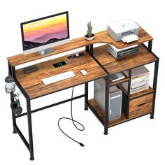 a computer desk with a monitor and printer on it