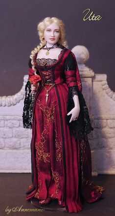 a doll is dressed in red and black