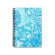 a spiral notebook with blue and white flowers on it