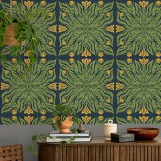 a room with a table, plant and wallpaper on the wall next to it