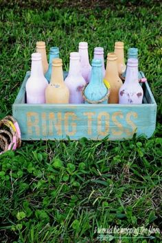 a crate filled with lots of bottles sitting in the grass