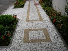 an empty street lined with plants and flowers