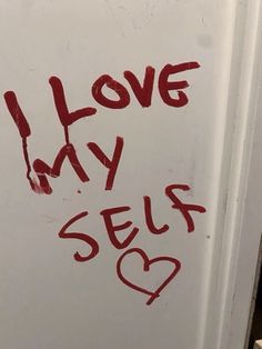 graffiti on the side of a refrigerator saying i love my self with red ink in it