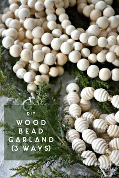 white bead garland with pine needles and greenery around it on a sheet of paper