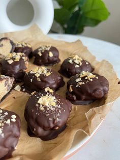 chocolate covered donuts are sitting on a plate