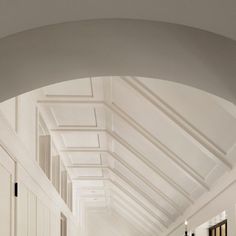 an empty hallway with white walls and ceiling