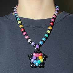 beaded necklace with kandi star charm + lobster claw clasp in back Kandi With Charms, Kandi Raver Outfits, Kandi Necklace Choker, Kandi With Perler, Cool Kandi Ideas, Cute Kandi Ideas, Necklace Ideas Beads, Kandi Necklace Ideas, Kandi Chain