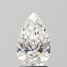 a pear shaped diamond on a white surface