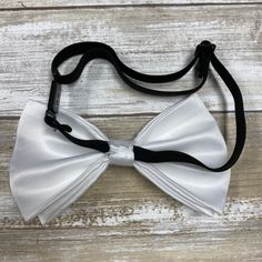 "Adults/Teens Elastic Suspender, Bow-tie All dimensions are approximate only Suspender Dimensions: Wide : 1.5\" (3.81cm) Adjustable from 25\" 63.5cm - 38\" (96.52cm) Bow Tie Dimensions: Length: 12cm (4.7 inches) Height (Widest Point): 6cm (2.36 inches) Height (Narrowest Point): 2.3cm (0.90 inches) Length of Bow Tie Strap at full length: 48cm (18.89 inches)" White Adjustable Standard Tie, Adjustable White Bow Tie Back, White Adjustable Bow Tie Back, White Standard Bow Tie, Adjustable White Bow Tie, White Adjustable Standard Bow Tie, Adjustable White Satin Bow Tie, Adjustable White Satin Bow, Adjustable White Bow For Black Tie Occasion