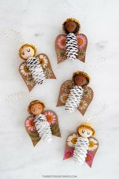 paper angel ornament with flowers on them