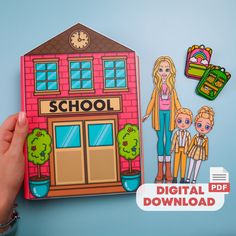 a hand holding up a cutout of a school with two children in front of it