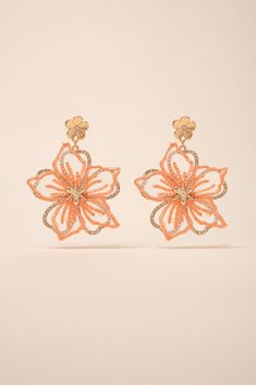 Make a statement with these beautiful Rhinestone Fabric Flower Earrings. These earrings are handmade with fabric flowers, embellished with shimmering rhinestones, creating a stunning and eye-catching look. Perfect for any special occasion or to add a touch of glamour to your everyday look. Shop now and add these unique earrings to your jewelry collection today! Size Length: 2.5 in (6.35 cm)Width: 2 in (5.08 cm) QualityEarrings are layered with two different flowers. Bottom flower with rhinestone Spring Party Beaded Earrings With Flower Shape, Spring Flower-shaped Beaded Earrings For Party, Spring Party Flower-shaped Beaded Earrings, Orange Flower Earrings For Party, Orange Flower Shaped Earrings For Party, Gold Beaded Flower Earrings For Party, Elegant Flower-shaped Beaded Earrings For Party, Fabric Flower Earrings, Rhinestone Fabric