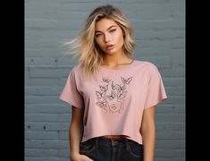 This unique bohemian butterfly artistic tee is perfect for any occasion.  Boho style with simplistic line art, butterflies, womans face.  Equipped with a flowy fit for easy-going appearances, this personalized women's cropped tee features a tailored sleeve along with a modest fit. Made with 65%/35% polyester/viscose fabric for stretchiness and equipped with a tear-away label for a scratch-free experience. .: 65% polyester, 35% viscose (fiber content may vary for different colors) .: Light fabric Trendy Pink Butterfly Print Tops, Trendy Tops With Butterfly Print And Relaxed Fit, Trendy Relaxed Fit Top With Butterfly Print, Casual T-shirt With Butterfly Print, Casual Pink T-shirt With Butterfly Print, Line Art Butterflies, Womans Face, Art Butterflies, Modest Fits