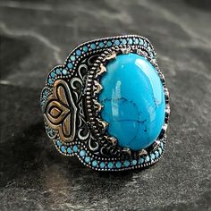 Men's Oval Blue Turquoise Gemstone Silver Ring , Silver 3 Petal Gonca Ring , Handmade Lucky Charm Symbol Ring , Floral Style , Gift For Him , Same Day For Shipping ✧ Product Details * Handmade İtem * Gender : Male / Female * Material : 925K Sterling Silver * Ring Weight : 18 Gram * Gemstone Type : Blue Turquoise ✔ Usage Details * Silver jewelry is very sensitive to chemicals. It is recommended to keep away from chemical substances such as cream, bleach, deodorant, detergent. * Silver jewelry can also darken quickly in salt water, that is, in sea water. For this reason, it is best to remove them when swimming in the sea. ✔ Shipping * Your orders placed on weekdays are delivered to the cargo on the same day. Your orders placed on the weekend are delivered to the cargo on Monday. ✔ Other Deta Blue Bohemian Jewelry With Accent Stones, Bohemian Blue Turquoise Ring With Stones, Bohemian Blue Oval Ring, Bohemian Oval Jewelry With Accent Stones, Vintage Blue Turquoise Ring With Natural Stones, Vintage Blue Rings With Natural Stones, Chemical Substances, Bleu Turquoise, Garnet Rings