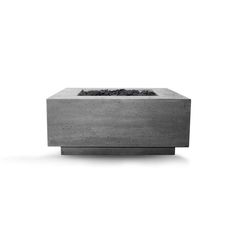 a concrete fire pit sitting on top of a white floor