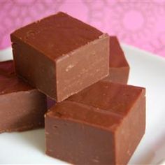 four pieces of chocolate sitting on top of a white plate