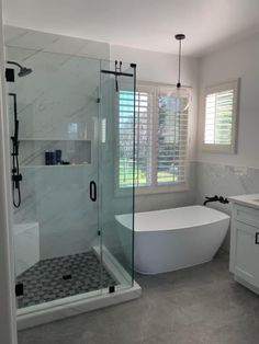 a bathroom with a tub, sink and shower in it's own area is shown