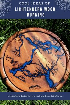 a wooden plate sitting in the grass with blue paint on it's surface and text that reads cool ideas of lichenberg wood burning