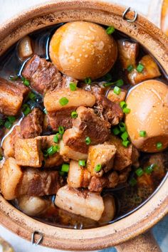 a wooden bowl filled with meat and potatoes