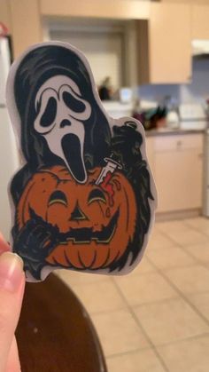 a person holding up a sticker with a ghost on it's face and mouth