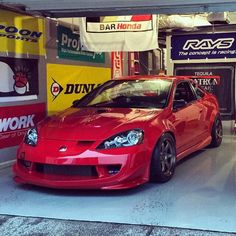 a red sports car parked in a garage