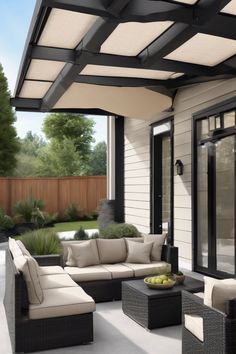 Modern outdoor patio with a seating area under a pergola with beige retractable canopy.