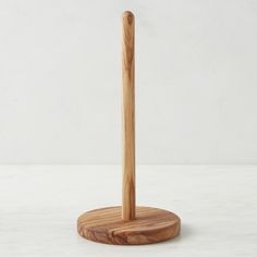 a wooden toothbrush holder on a white surface