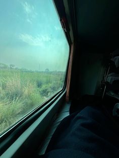 the view from inside a train looking at grass