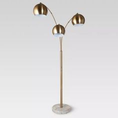 three light floor lamp with marble base and four lights on each side, in gold