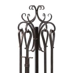 an iron coat rack with ornate designs on the front and back sides, holding two keys