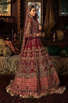 a woman in a red and gold bridal gown