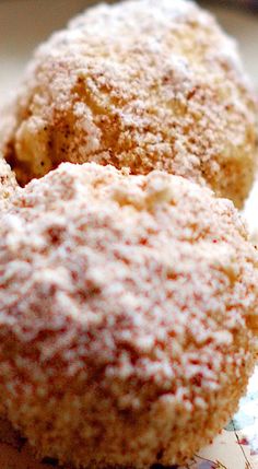 three powdered donuts sitting on top of a plate