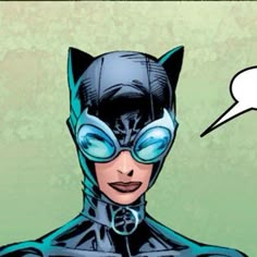 a comic character wearing a cat mask and blue goggles with an empty speech bubble above her