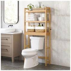 a bathroom with a wooden shelf over the toilet